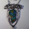 An Arts and Crafts enamel fish amongst reeds pendant, circa 1930 SOLD