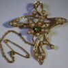 An Edwardian 15 carat gold demantoid garnet and seed pearl floral brooch pendant of Art Nouveau influence, circa 1905 SOLD