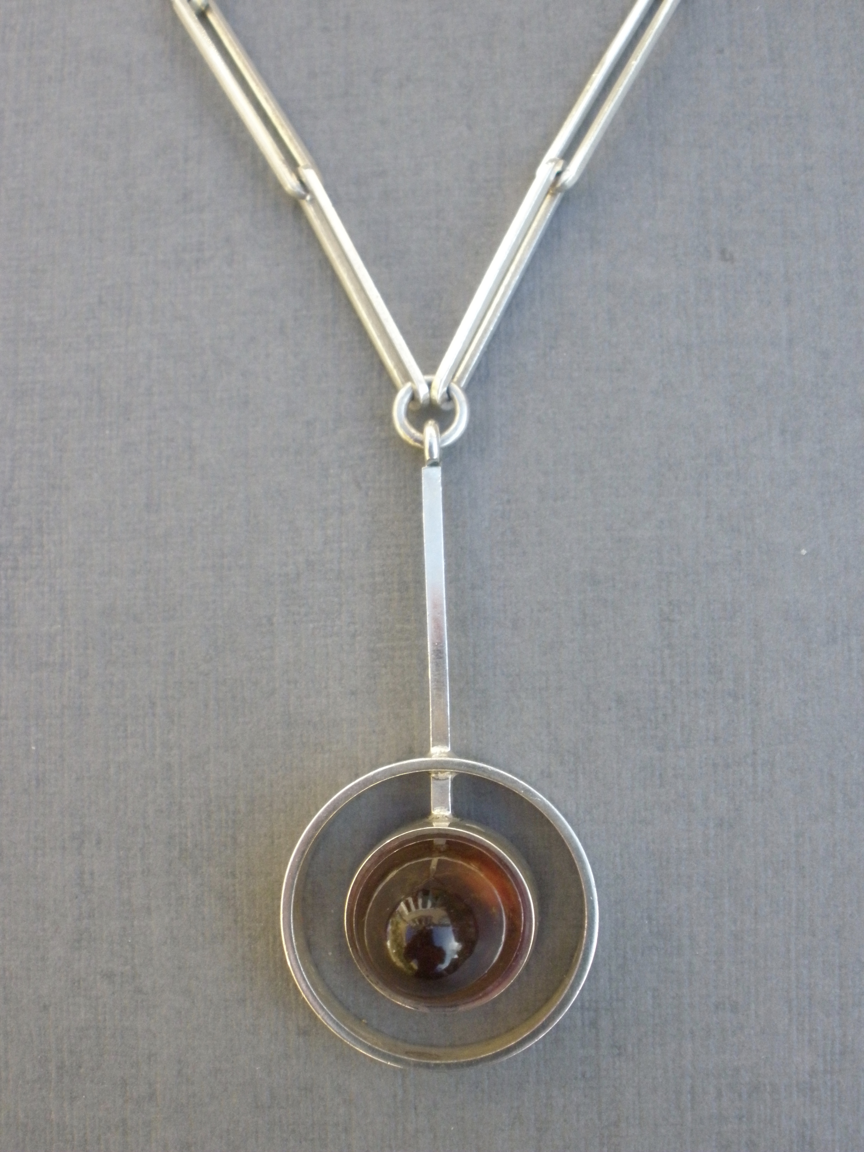 Niels Erik From, an amber silver pendant on chain, Denmark, London
